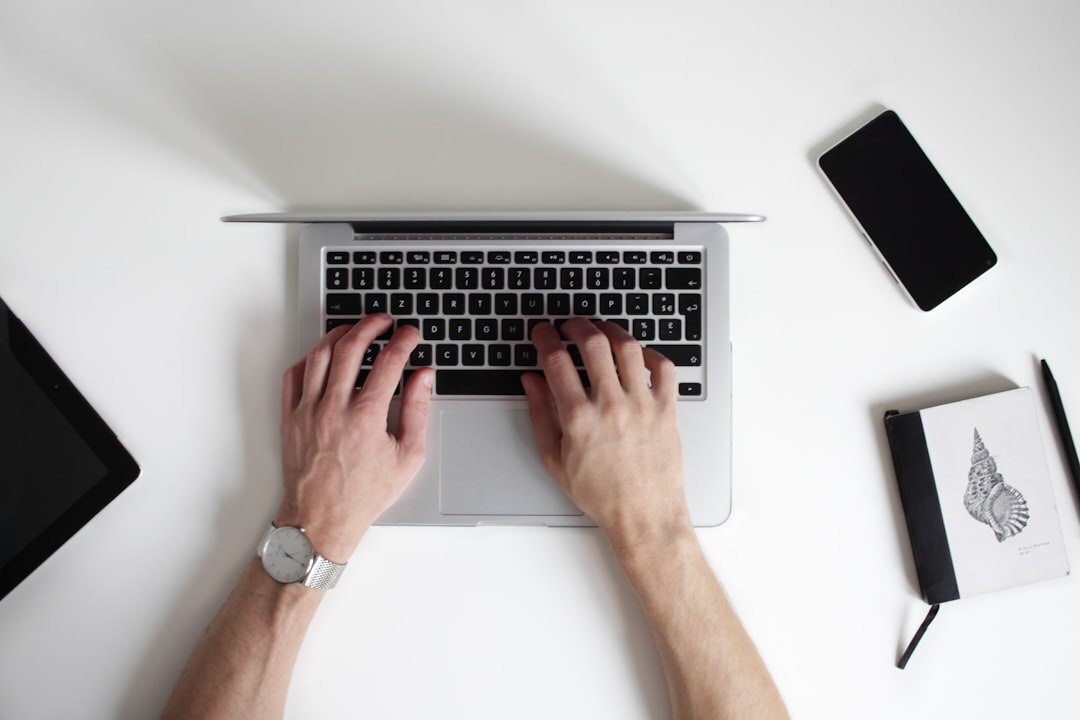 writer typing on laptop