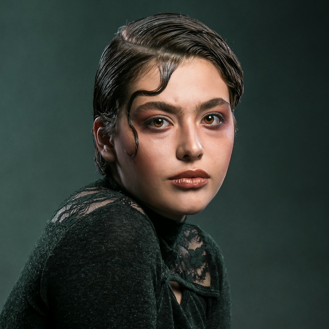 Studio portrait of a young woman, editorial team member
