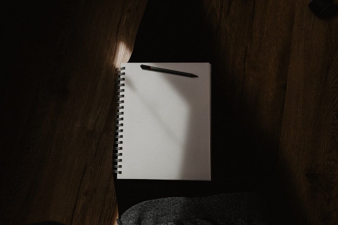 person writing in notebook