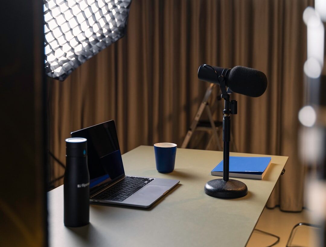 Wide shot of a modern podcast studio with recording equipment